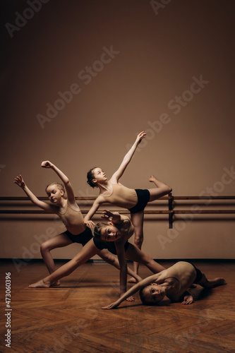 Image of a group of modern little ballerinas standing in a modern dance pose. Copy space