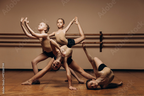 image of a group of modern little ballerinas standing in a modern dance pose. Copy space