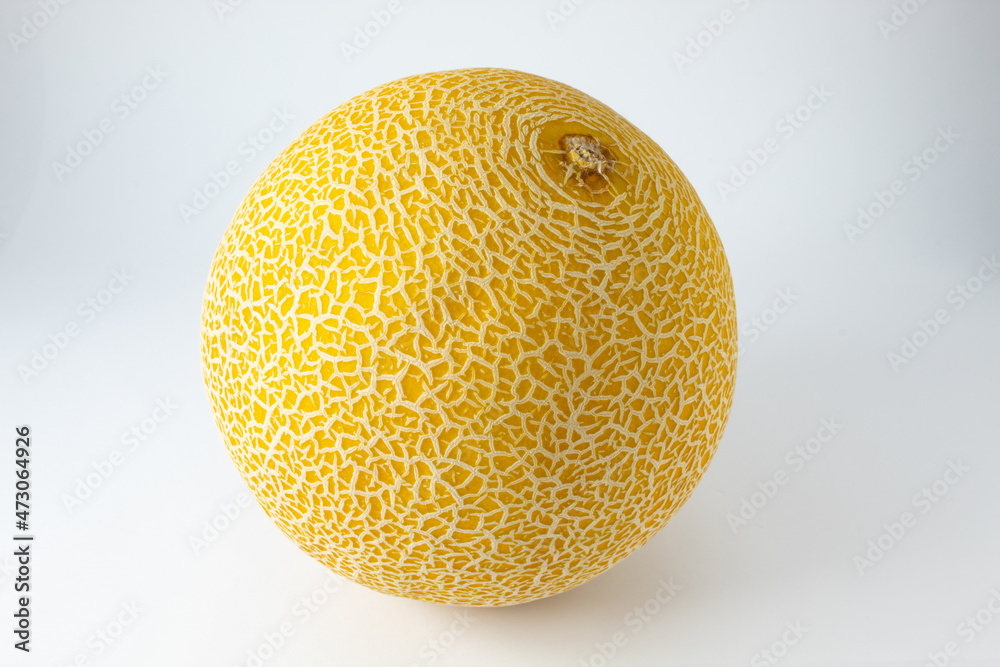 Ripe and whole Gaul melon. Tropical fruit with white streaks on the yellow skin Ripe and whole Gaul melon. Tropical fruit with white streaks on the yellow skin
