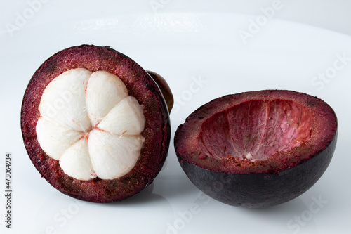 Mangosteen fruit cut in half, with pulp showing