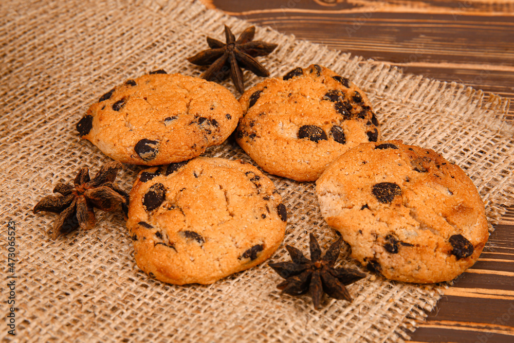 Tasty chocolate chips cookies with anise on wooden table Tasty chocolate chips cookies with anise on wooden table