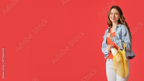 Young woman putting bottle ...
