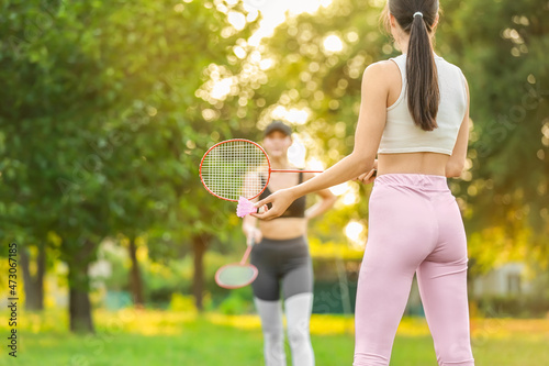 Young women playing badmint...