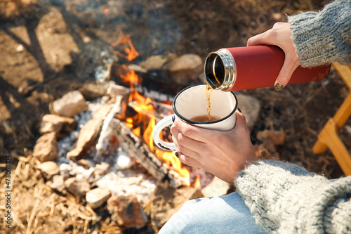 Woman drinking hot tea in a...