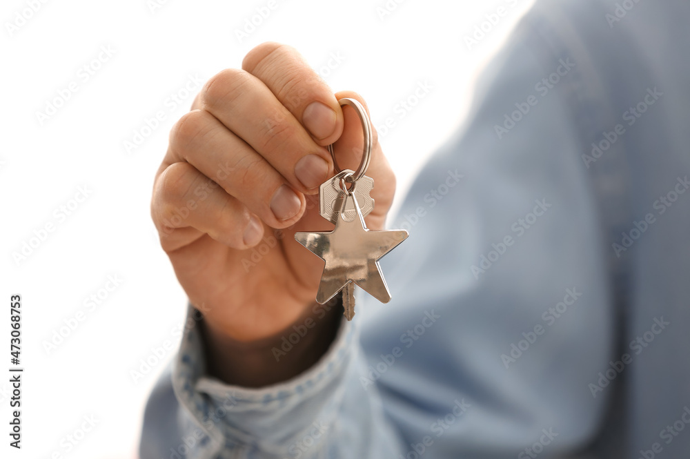 Man holding key on chain, closeup