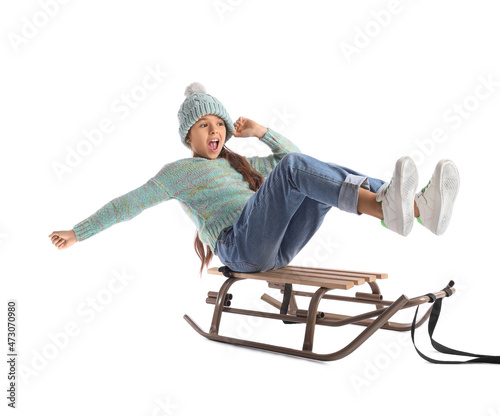 Sledding little girl on whi...