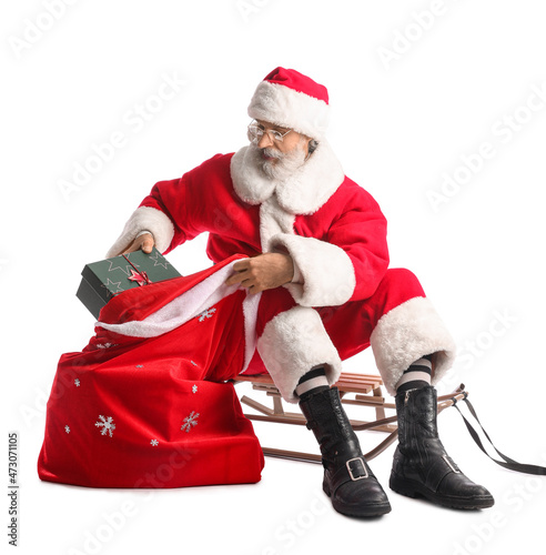 Santa Claus with sled and b...