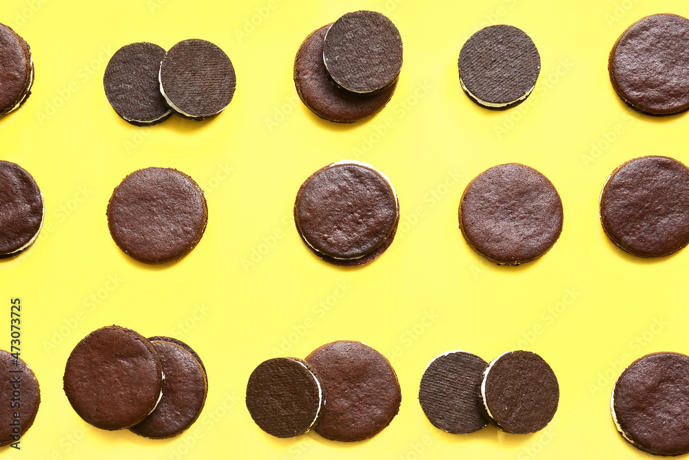 Tasty chocolate cookies with cream on yellow background Tasty chocolate cookies with cream on yellow background