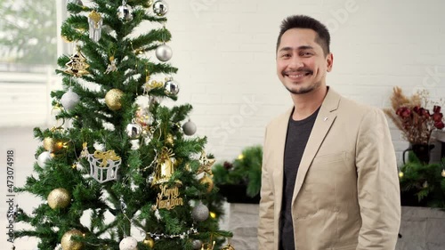 Young asian man hum with happiness on Christmas and new year celebration, holiday concept. photo