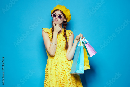 smiling woman with multicolored bags posing isolated background