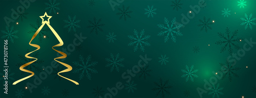 golden christmas tree on green snowflakes background