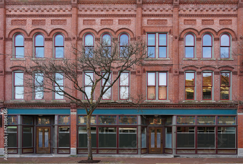 Facade of old fashioned 19th century main street brick commercial building