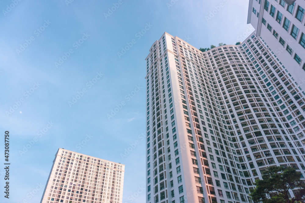 High-rise apartment buildings in the city center. Low angle shot of modern architecture in the blue sky. Futuristic cityscape view High-rise apartment buildings in the city center. Low angle shot of modern architecture in the blue sky. Futuristic cityscape view