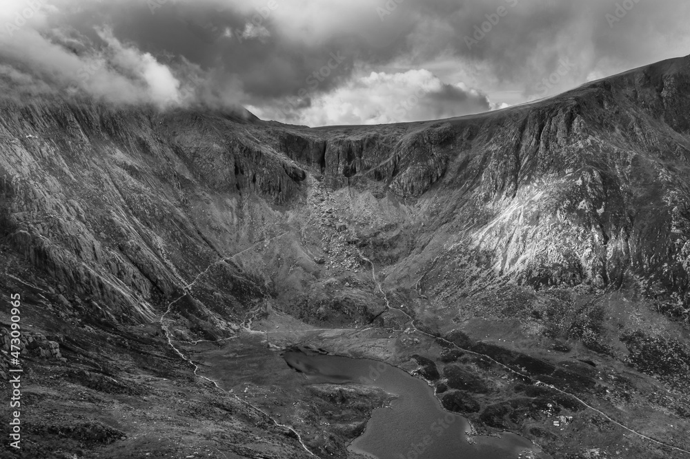 Black and white Aerial view of flying drone Epic dramatic Autumn landscape image of Llyn Idwal in Devil's Kitchen in Snowdonia National Park with gorgeous light Black and white Aerial view of flying drone Epic dramatic Autumn landscape image of Llyn Idwal in Devil's Kitchen in Snowdonia National Park with gorgeous light