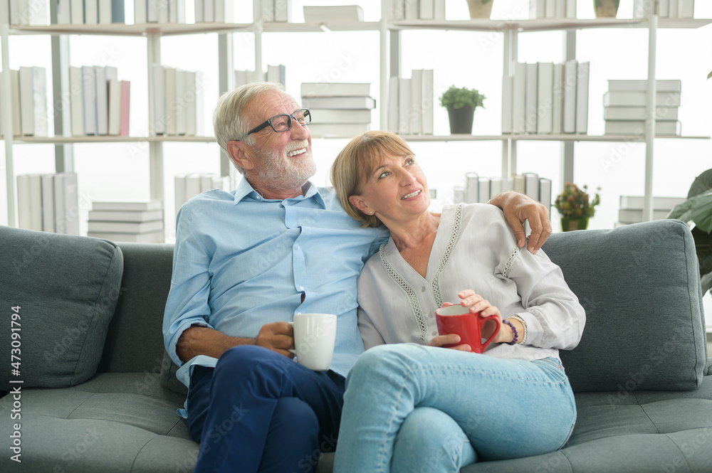 Happy Caucasian seniors couple are drinking coffee in home , relaxing and health care concept .