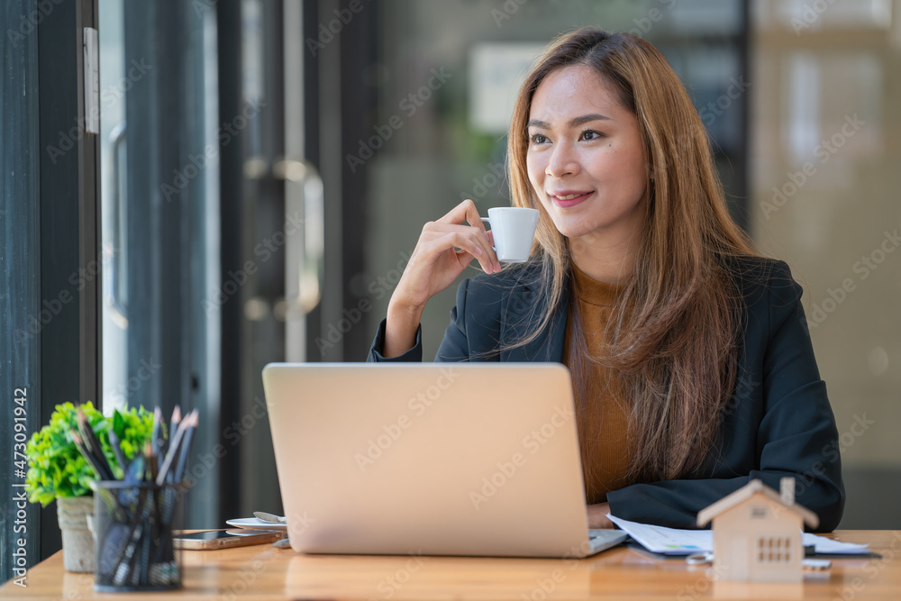 businesswoman having tea or coffee in-home office. businesswoman having tea or coffee in-home office.