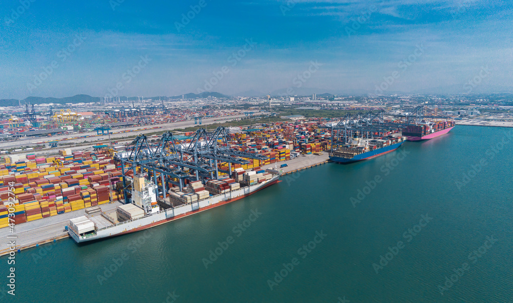 Aerial top view containers ship cargo business commercial trade logistic and transportation of international import export by container frieght cargo ship in the open seaport.