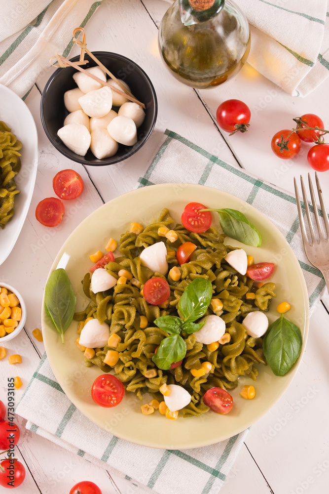 Fusilli pasta with cherry tomatoes and sweet corn.