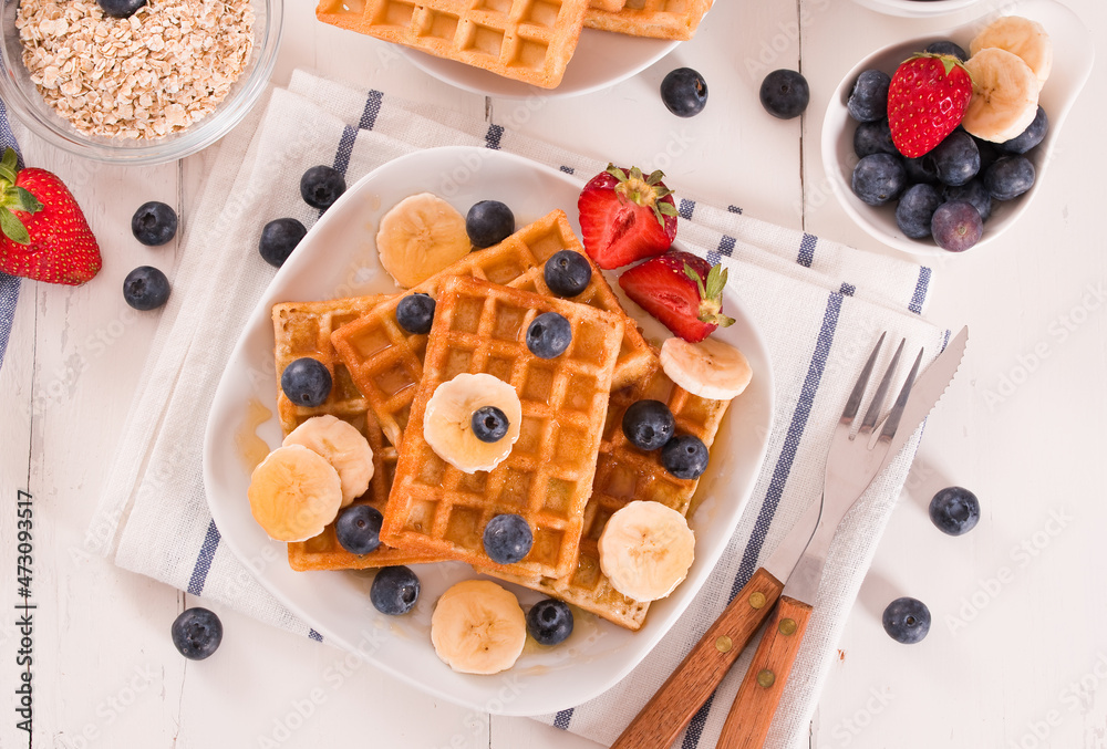 Waffles with blueberries, bananas and honey. Waffles with blueberries, bananas and honey.