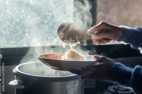 Photos selective focus,soft focus Women hand holding and using wood ladle to scoop stea
