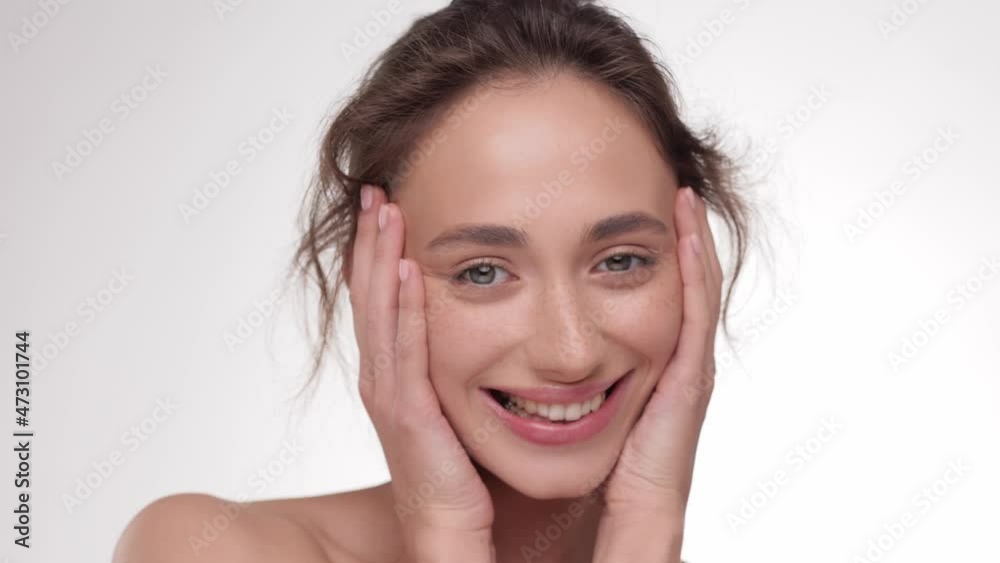 Close up Portrait Happy young Brunette hair Female model with fresh skin, white smile and natural facial makeup. Woman look at the camera and smiling. Concept of cosmetology. Close up Portrait Happy young Brunette hair Female model with fresh skin, white smile and natural facial makeup. Woman look at the camera and smiling. Concept of cosmetology.