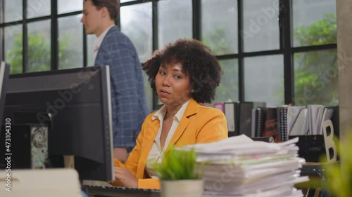 Close up of overwhelmed business woman working under pressure in company office. Stressed office worker sitting at desk and working overtime late at night.