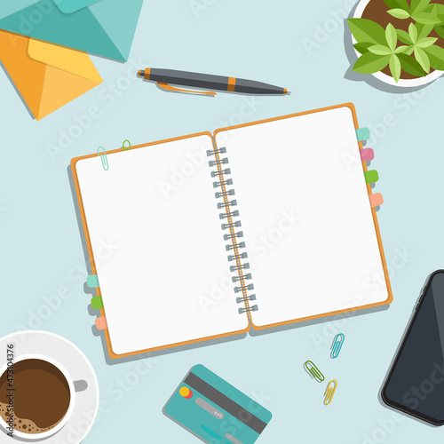 Blank open spiral notepad. Work desk with blank notepad, stationery, telephone, coffee shop and flower. Copy space 