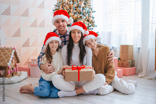 Fotografie Happy young family with kids holding christmas presents