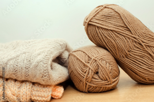 Two skeins of woolen yarn for knitting and warm knitted sweaters.