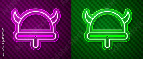 Glowing neon line Viking in horned helmet icon isolated on purple and green background. Vector