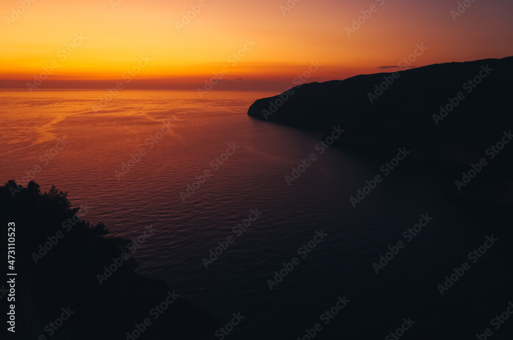 Fiery sky as the sunset over a bay in Zakynthos island, Greece