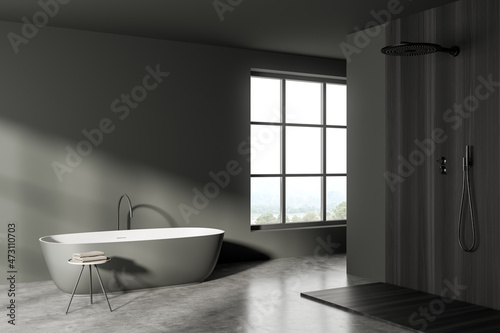 Dark bathroom interior with bathtub  shower and window  concrete floor. Mockup