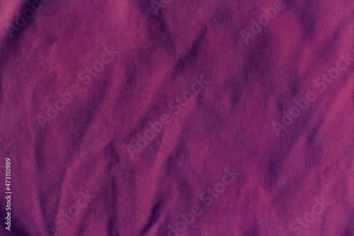 Flax. Crumpled, purple fabric.