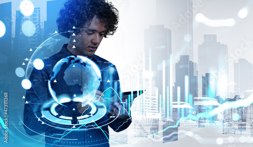 Businessman using tablet, earth sphere and New York city view wi