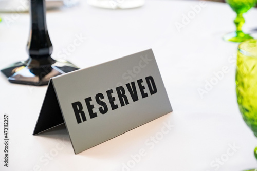 Table at restaurant with reserved sign close-up