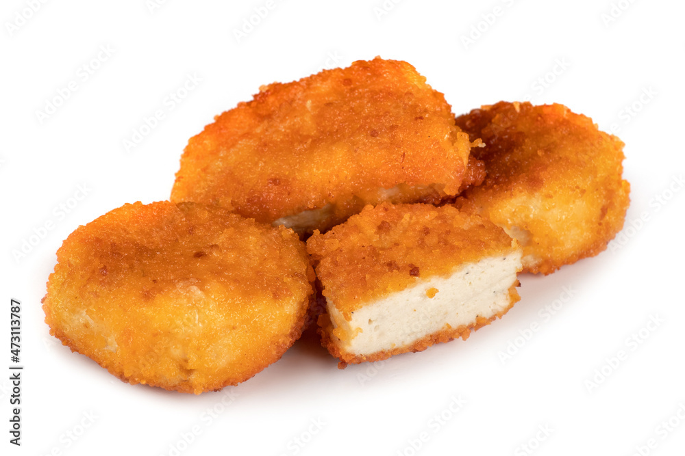 A pile of chicken nuggets isolated on a white background A pile of chicken nuggets isolated on a white background
