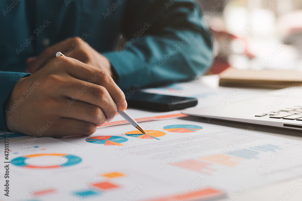 male executive analyzing and planning business sales performance from financial data, analyzing finance sales data and economic growth graph chart.