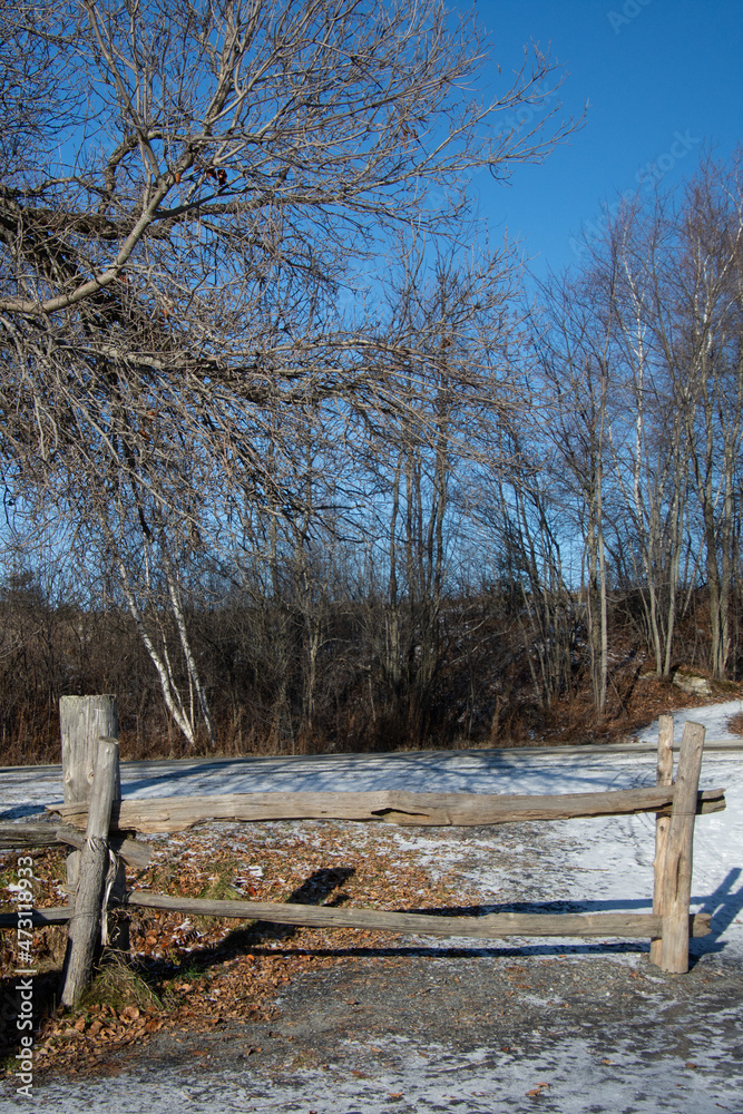 Old wooden fence in a field in Canadian winter in Quebec 