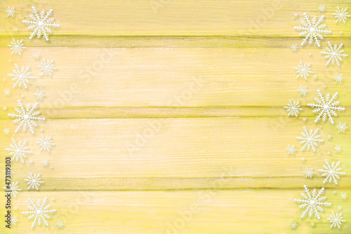 Winter wooden beige yellow nature background with snowflakes two sides. Texture of painted wood horizontal boards. Christmas, New Year card with copy space. Can be used for websites, brochures, poster