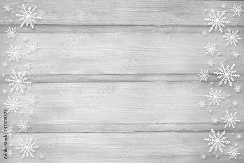 Winter wooden grey nature background with snowflakes two sides. Texture of painted wood horizontal boards. Christmas, New Year card with copy space. Can be used for websites, brochures, posters, print