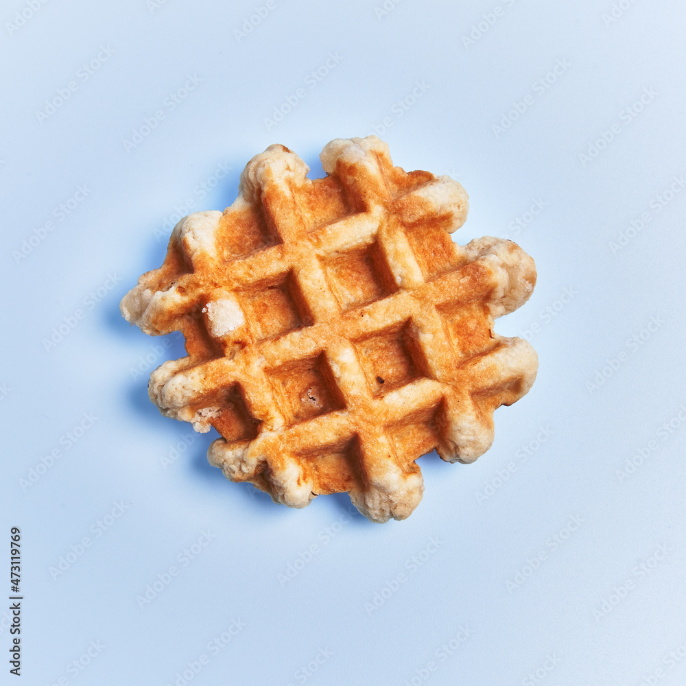 Single delicious waffle over blue background Single delicious waffle over blue background