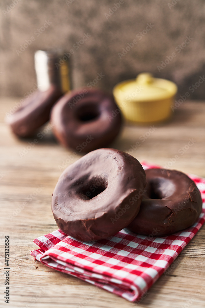  Bunch of chocolate doughnuts on a wooden surface