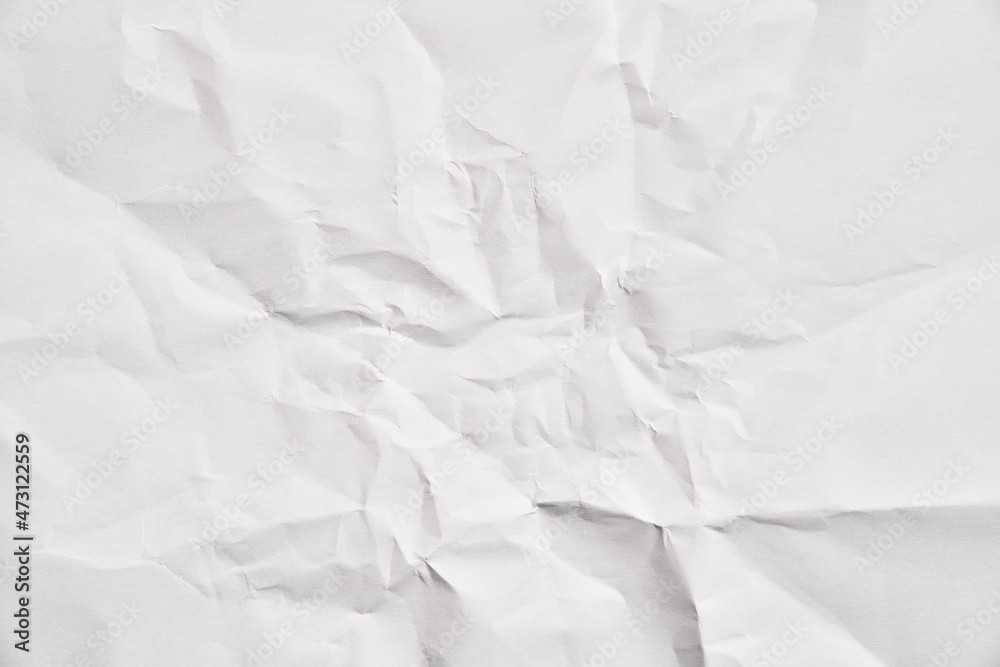 Obraz premium White crumpled paper texture with wrinkles. Damaged and torn sheet