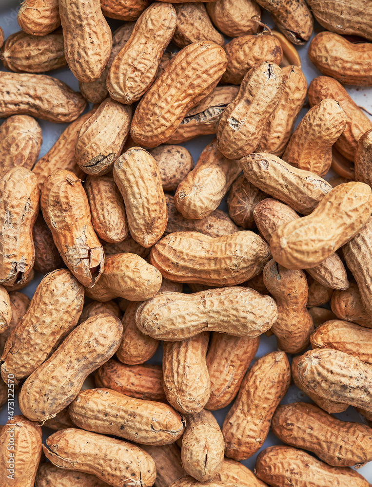 Healthy roasted unpeeled peanuts. Brown nuts texture Healthy roasted unpeeled peanuts. Brown nuts texture