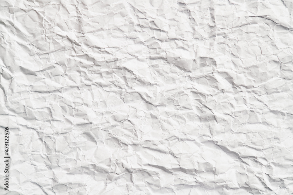 White crumpled paper texture with wrinkles. Damaged and torn sheet White crumpled paper texture with wrinkles. Damaged and torn sheet