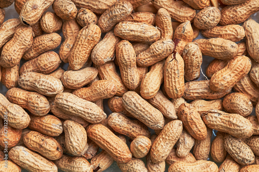 Healthy roasted unpeeled peanuts. Brown nuts texture Healthy roasted unpeeled peanuts. Brown nuts texture