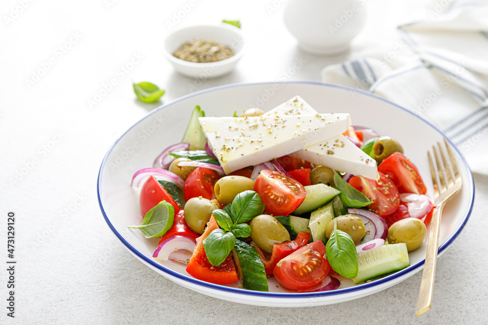 Greek or horiatiki salad with fresh vegetables and feta cheese, dressed with olive oil, traditional Greek cuisine salad