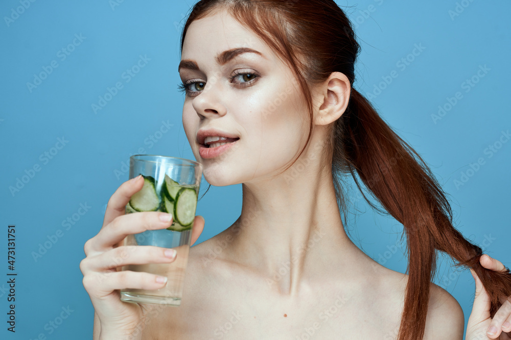 woman with bared shoulders cucumber health drink blue background woman with bared shoulders cucumber health drink blue background