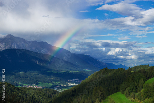 A Rainbow in front of a mountain range after the storm on a summer's day.