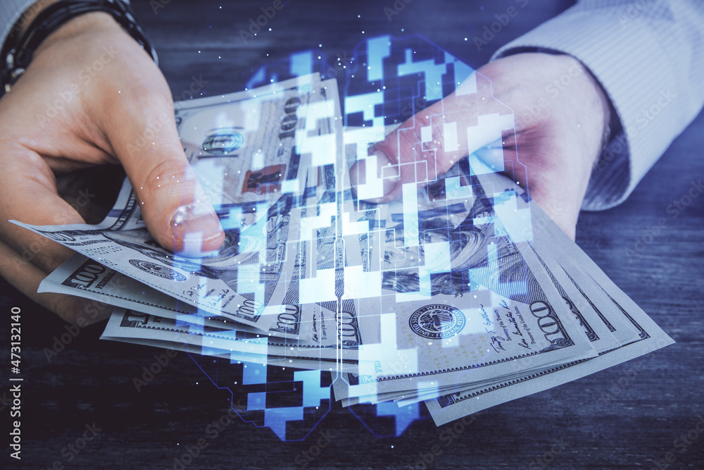 Multi exposure of technology drawing hologram and us dollars bills and man hands. Data concept Multi exposure of technology drawing hologram and us dollars bills and man hands. Data concept